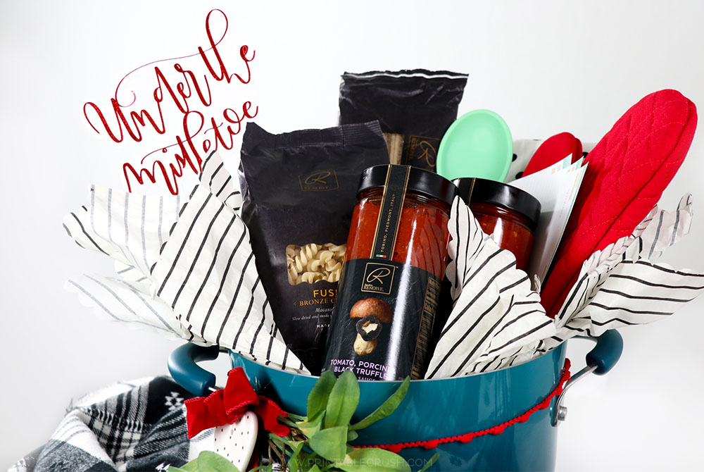 Fill a pot with cooking utensils, recipe cards, and Signature RESERVE™ pasta and canned red sauce to create this cute Newlywed Christmas Gift Basket Idea!